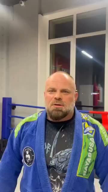 Тренер по бразильскому джиу-джицу в синем кимоно